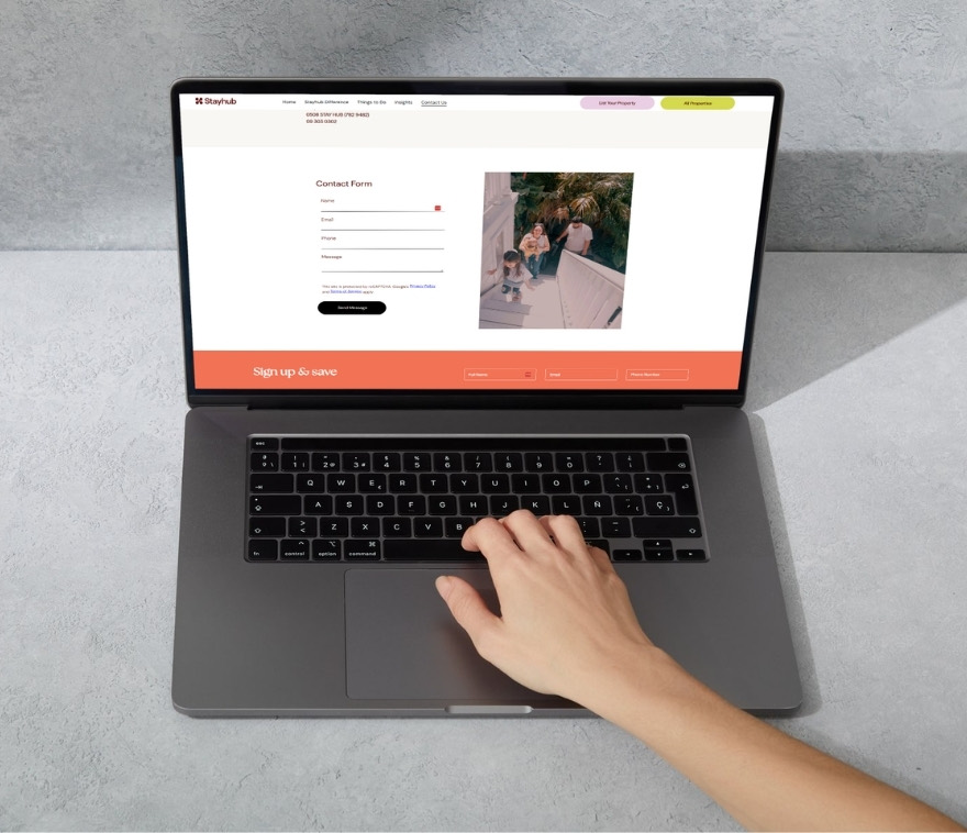 The Stayhub contact page open on a laptop, with the form to reach the guest team